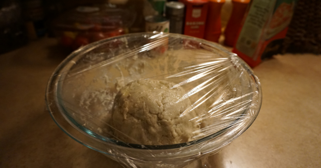 A picture of gluten-free pizza dough rising in a bowl