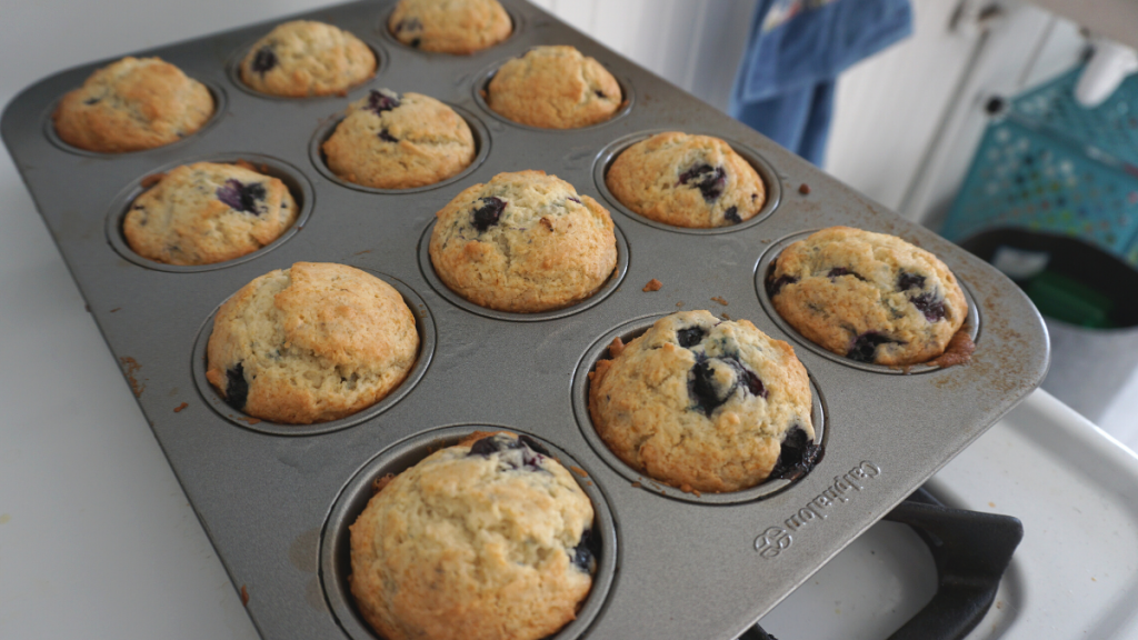 Vegan frozen blueberry muffins in a muffin tin
