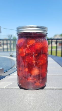 Strawberry pie filling jar on table outside
