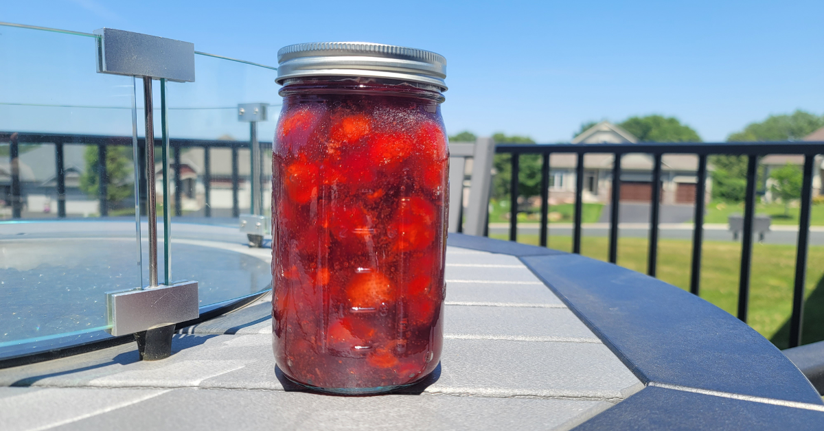 Strawberry pie filling on a table outside